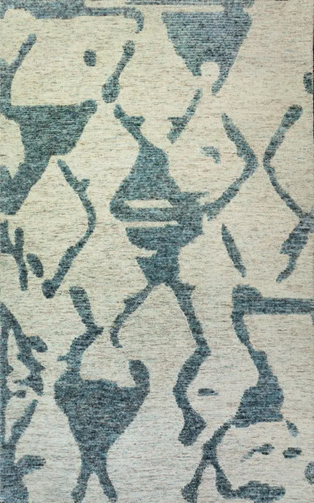 Abstract blue floral pattern on a light beige rug.