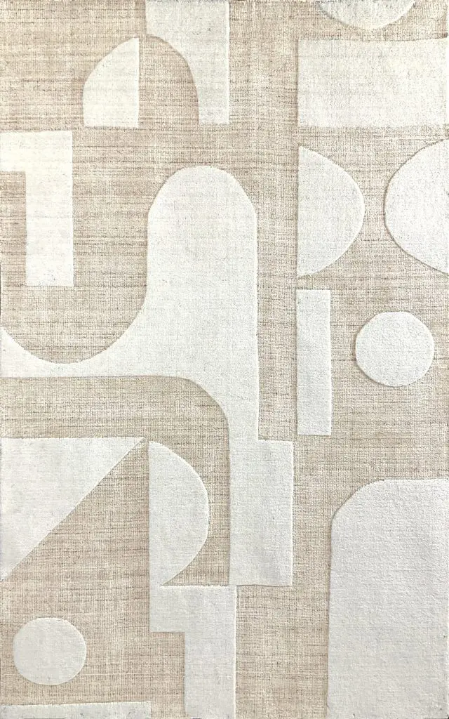 Abstract geometric rug pattern in beige and cream with circles, arches and rectangles at the close-up texture level.